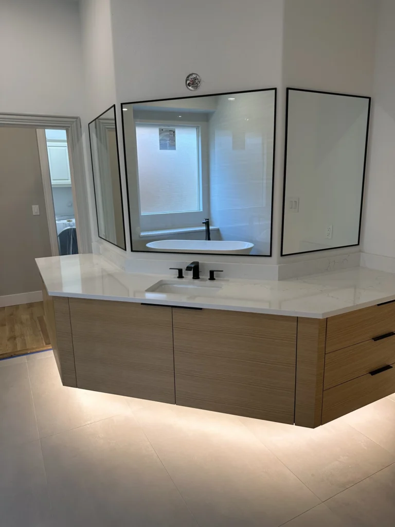 Modern floating vanity with premium bathroom renovation features, soft under-cabinet lighting, and contemporary mirrors in a remodeled Plano, TX bathroom.