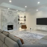 Beautiful Plano home renovation featuring a sleek modern living room with marble fireplace, built-in shelving, recessed lighting, and open layout showcasing full home remodeling excellence by local experts.