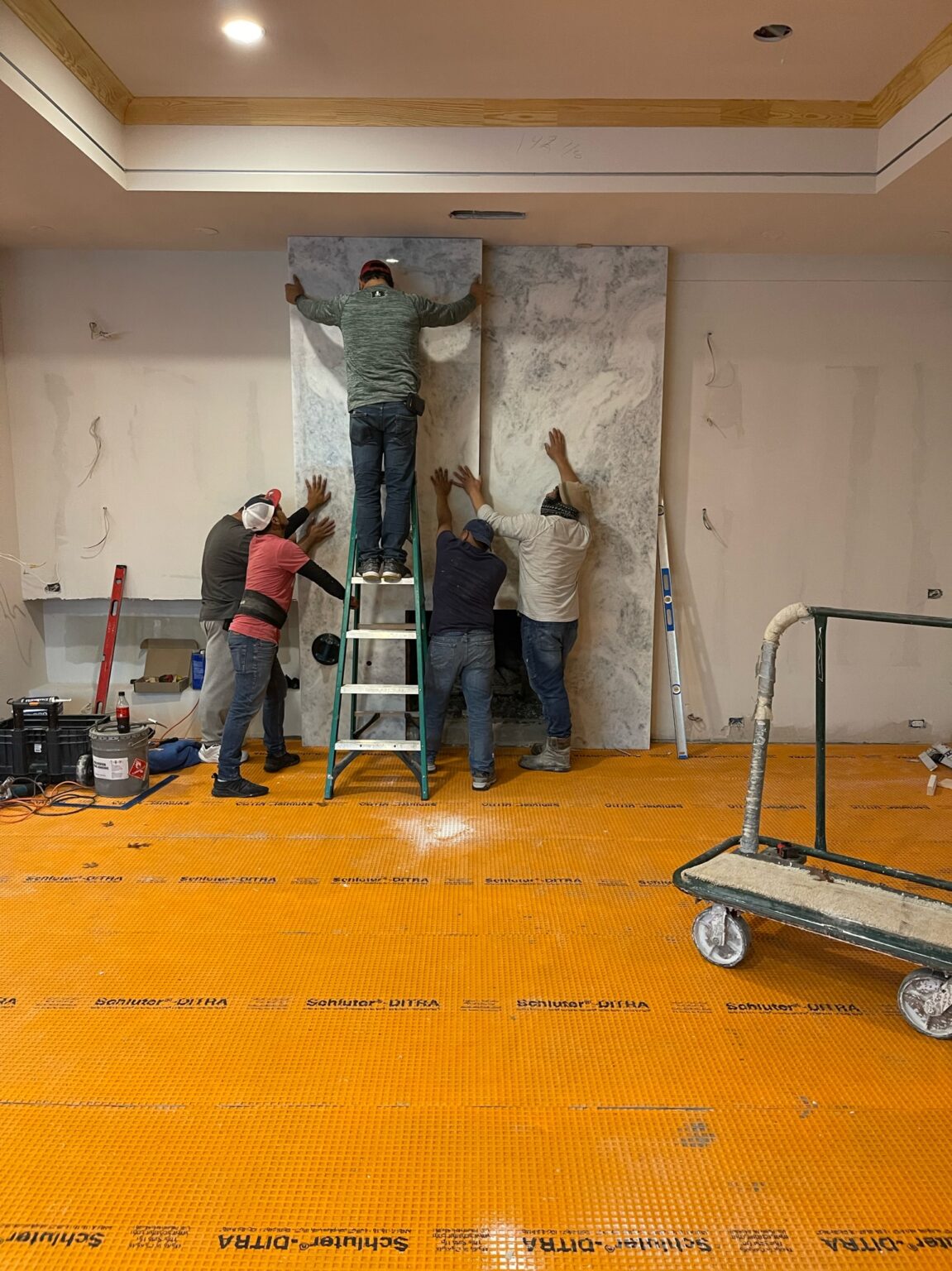 Professional crew working on an interior remodel while homeowners hire a Luxury Home Renovation Contractor in Far North Dallas for high-end home upgrades.