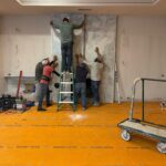 Professional crew working on an interior remodel while homeowners hire a Luxury Home Renovation Contractor in Far North Dallas for high-end home upgrades.