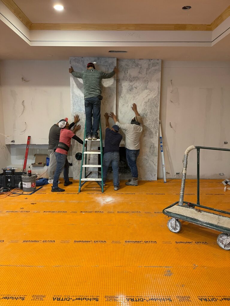 Professional crew working on an interior remodel while homeowners hire a Luxury Home Renovation Contractor in Far North Dallas for high-end home upgrades.
